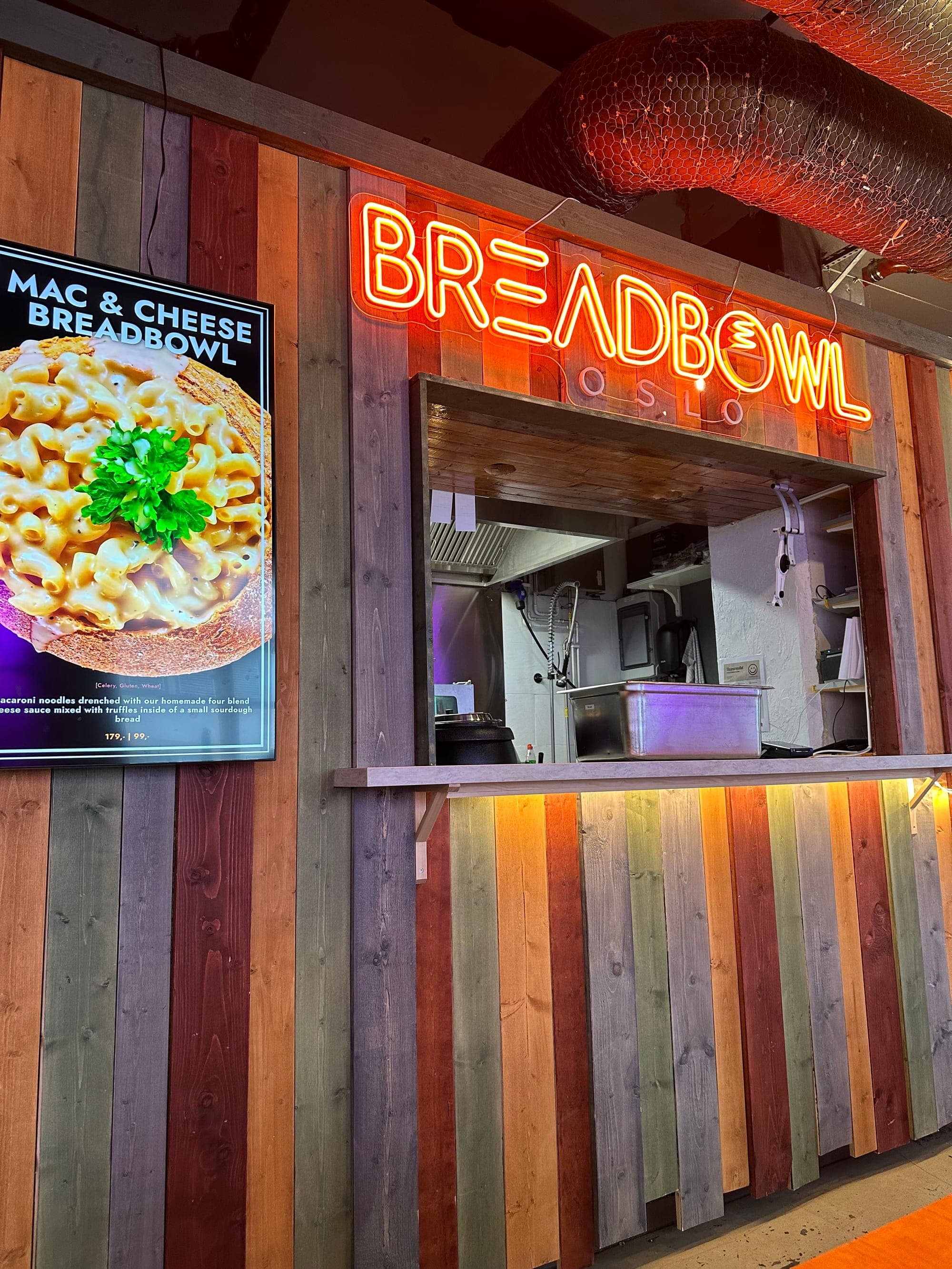 Neon-lit Breadbowl stall counter inside Oslo Street Food