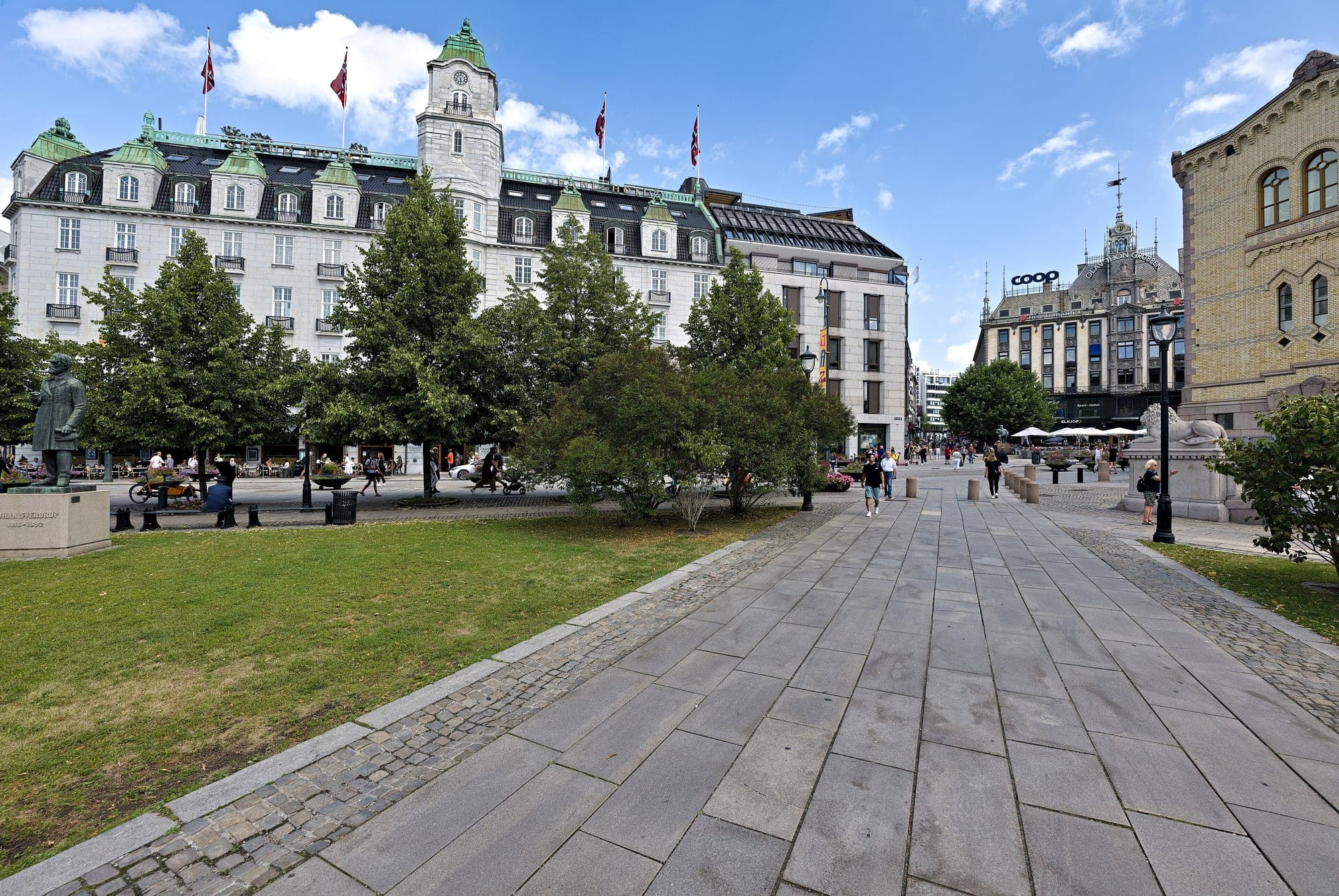 The Grand Hotel's tower and flags seen across the paved square