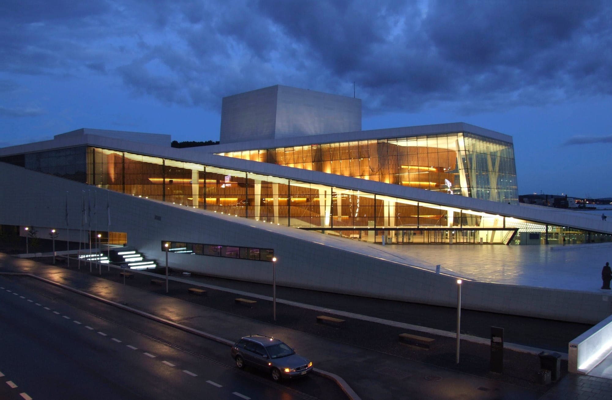 The Opera House glowing golden through glass at dusk
