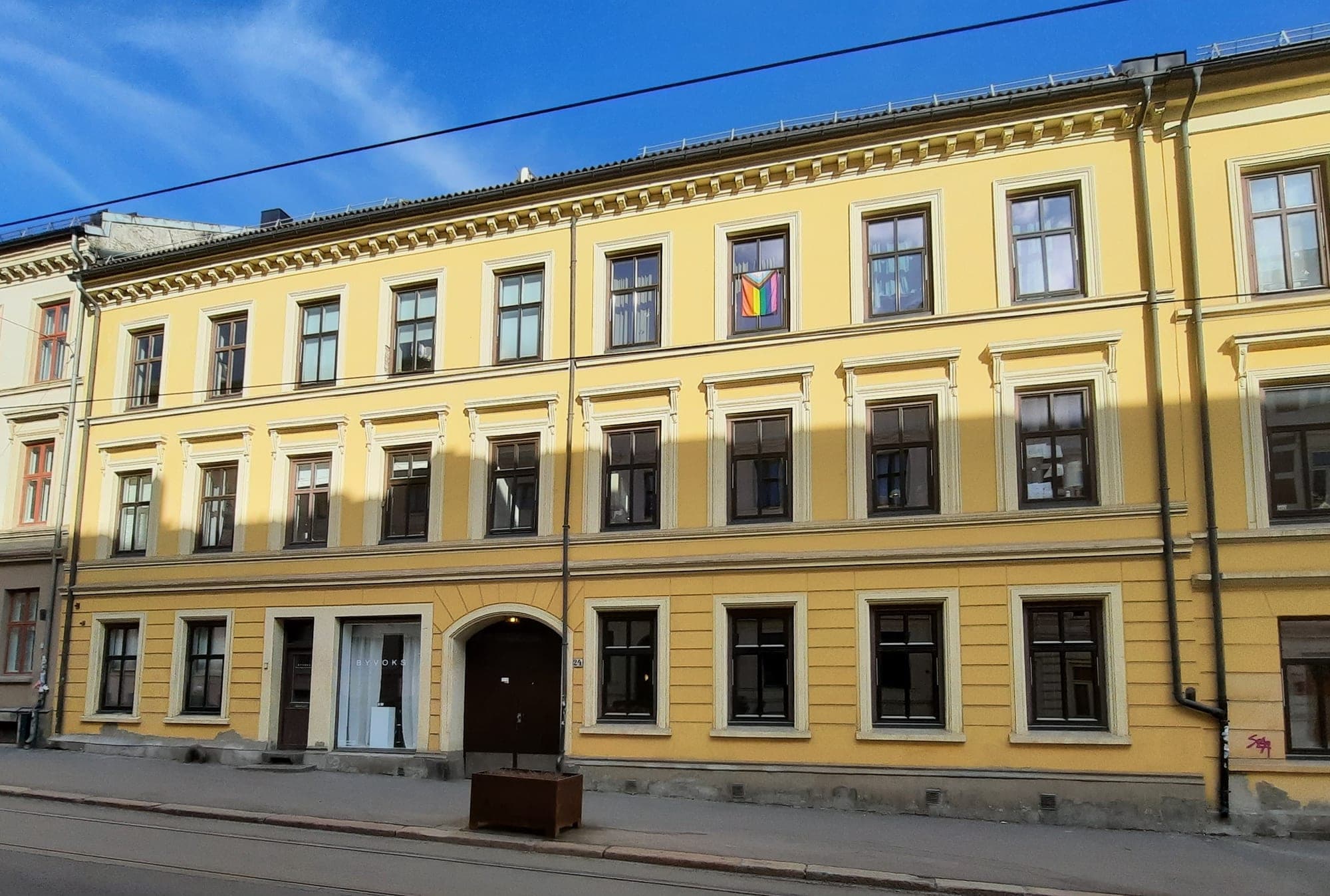 Sunlit yellow three-storey building housing the candle studio
